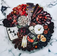 a platter filled with lots of different types of food on top of a marble table