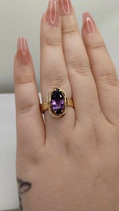 Here we have a vintage ring that was custom made for it's previous owner.  This stunning piece features a 14.5 x 7mm natural marquise amethyst in a 4 prong setting.  The amethyst measures approximately 2.60 total carat weight.  The setting is a bit off centered but it is no less gorgeous because of that.  Crafted in solid 14K yellow gold.  The back of the band measures 7.7mm  Specs: Stone Type: Amethyst  Stone Class: Natural Topaz Total Carat Weight: ~ 2.60 CTW  Metal: 14K Yellow Gold Hallmarked: (14K)  Ring Size: US 8 1/2 Ask us about re-sizing  Ring Weight: .17 oz. or 5.4 grams  IMPORTANT NOTICE:  If you would like to inquire about re-sizing, please message us and wait for a response before you finalize your purchase.  If the re-sizing is possible we then add the re-sizing fee to your to Vintage Amethyst Ring Gold, Gold Amethyst Marquise Ring, Classic Marquise Amethyst Ring, Luxury Marquise Cut Amethyst Ring, Luxury Gold Marquise Amethyst Ring, Luxury Marquise Amethyst Ring Fine Jewelry, Luxury Marquise Amethyst Ring, Gift Yellow Gold Marquise Amethyst Ring, Luxury Amethyst Marquise Jewelry