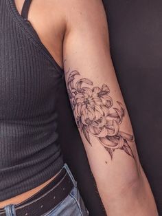 a woman with a flower tattoo on her arm