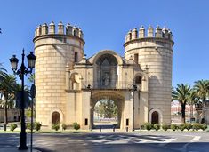 an old castle like building with a clock on it's front door and two towers