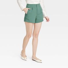 Create an array of cool and confident warm-weather looks with these High-Rise Tailored Shorts from A New Day™. Made from lightweight fabric with a hint of spandex, these high-rise shorts offer all-day cool comfort and easy movement. Designed with a fly hook and zipper, they feature two side pockets to add functional flair to your look, while the solid hue makes for easy pairing with different tops. A New Day™: Style that goes wherever you do. True Summer, Target Dress, Dressy Shorts, Target Clothes, Work Shorts, Tailored Shorts, Green Brands, Pleated Shorts, High Rise Shorts