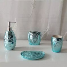 a bathroom set consisting of soap dispenser, toothbrush holder and cup