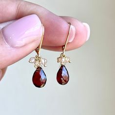 Garnet and Citrine Earrings, January Birthstone, Tiny Red and Beige Teardrop Earrings in Gold or Silver, Minimalist Red Jewelry Gift for mom These vibrant dainty earrings feature faceted garnet teardrops with 4 champagne citrine rondelles wire wrapped on top in your choice of gold filled or sterling silver. The Earrings are suspended from ear wires in the finish of your choice. These are tiny earrings but they are full of color and details. Ideal earrings for a woman born in January, as this is their birthstone.  About These Earrings: - Stone: Garnet and Champagne Citrine - Birthstone: January - Stone Size: 8 mm Garnets, 3mm champagne citrine rondelles - Earring Size: 15 mm - Finish: Choice of 14k Gold Filled or Sterling Silver - Genuine Natural Gemstones - Gift Wrapping Included. Personal Red Drop Crystal Earrings As Gift, Red Teardrop Garnet Earrings, Red Garnet Teardrop Earrings, Red Teardrop Crystal Earrings, Red Teardrop Pearl Drop Earrings, Dainty Red Jewelry With Ear Wire, Crystal Briolette Earrings As Gift, Red Pearl Drop Earrings As Gift, Teardrop Garnet Red Jewelry