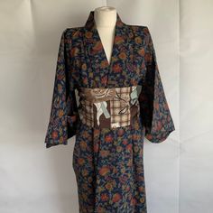 Vintage Japanese kimono. Dark blue with red and ochre floral design, Fabric unknown, but strong, good quality and hard wearing. Straight and hand stitched. Armpit to armpit 23 inches 59 cm, back length 61 inches 154 cm. cotton lined back yoke and seat. Very Good vintage condition.  As with all kimono, hang up to air, or specialist clean, generally should not be washed, although some can be successfully hand washed. All the kimono that I sell have been steamed. Any marks are minor, and historic! Floral Print Kimono For Tea Ceremony, Traditional Blue Floral Print Kimono, Traditional Blue Floral Kimono, Blue Long Sleeve Kimono With Floral Print, Blue Floral Print Long Sleeve Kimono, Vintage Floral Print Kimono, Traditional Blue Long Sleeve Kimono, Vintage Long Floral Print Kimono, Blue Kimono With Kimono Sleeves For Tea Ceremony