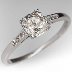 This beautiful circa 1930s diamond engagement ring is centered with one (1) old mine cut diamond weighing 0.82 carat that is set into a four-split prong setting. The shoulders of the ring are each accented with three (3), channel set, round single cut diamonds. The ring measures 6.1mm at the top, rises 4.9mm above the finger, tapering to 1.1mm wide and 0.9mm thick at the base of the shank. The ring is currently a size 7.75. One of the side diamonds has a small nick on the side that cannot be seen without magnification. 1930s Engagement Ring, Channel Set Diamond Engagement Ring, Engagement Ring Platinum, Old Mine Cut Diamond, Engagement Rings Platinum, Aquamarine Jewelry, Rings Diamond, Channel Set, March Birth Stone