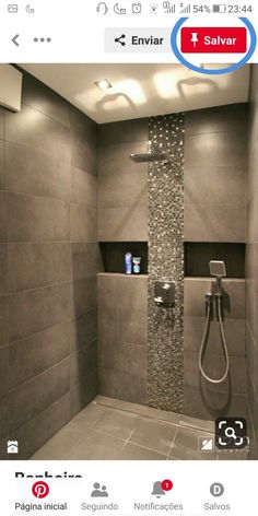 a walk in shower sitting next to a tiled wall