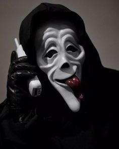 a person wearing a mask and holding a cell phone