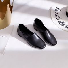 Slip-on Loafers With Branded Heel Counter, Low Heel Flats With Branded Insole For Office, Low Heel Faux Leather Court Shoes For Office, Sleek Round Toe Slip-ons For Office, Faux Leather Low Heel Court Shoes For Office, Sleek Office Slip-ons With Round Toe, Elegant Faux Leather Slip-ons With Round Toe, Medium Width Pointed Toe Flats For Office, Leather Low Heel Flats For Office