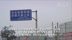 there is a blue sign that says environmental protection is as important as economic development in china