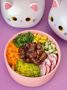 a pink bowl filled with meat and veggies on top of a purple surface