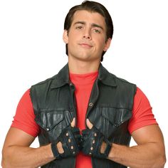 a man wearing a leather vest and red shirt