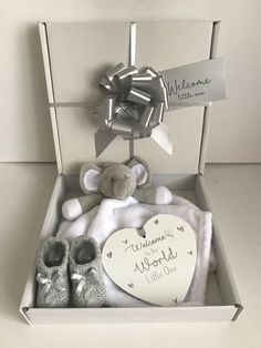 a baby gift box with a teddy bear and booties