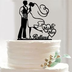 a wedding cake topper with a bride and groom on it