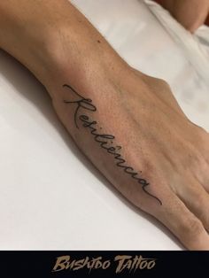 a person with a tattoo on their left hand and the word ferroro written in cursive writing