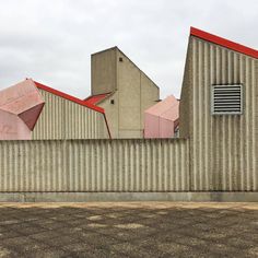 the building has red roof tops and is made out of corrugated