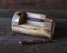 a pen resting on top of a wooden box