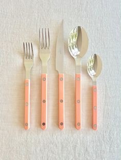 four forks, two knives and three spoons on a table