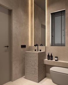 a modern bathroom with two sinks and a toilet in it's center area, along with a large mirror on the wall