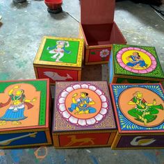 colorful painted boxes sitting on top of a floor