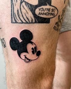 a man with a tattoo on his leg that says you're so annoying and mickey mouse