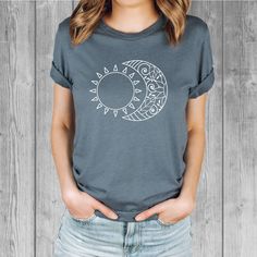 Women's Bella Tri-Blend relaxed unisex fit T-shirt with a Sun and Moon screen printed graphic design.  Super soft, stretchy, and comfy material.   Available with black or white ink! FIT: Follow the image size chart Unisex Fit - Runs Large - Long Length  Suggest sizing down if you prefer a more fitted look instead of relaxed -  Bella 3.8 oz  Super Soft hand and lightweight  -  Tri Blends:  50% Poly, 25%  Cotton, 25%  Rayon -  Does not shrink -  Hand screen printed to order in Oregon - Model is wearing a size small Fashion Fitted Style  http://etsy.me/2qjx3lC ♥ All of our tees are hand-printed to order in our shop in Portland Oregon! ♥ RETURNS & EXCHANGES We gladly accept exchanges and returns if not worn.   Please follow the chest measurement size guide for fit if you are unsure.  We custom Casual Short Sleeve T-shirt With Moon Print, Trendy Crew Neck T-shirt With Moon Print, Cotton Crew Neck Top With Moon Print, Trendy Moon Print Crew Neck Top, Trendy Crew Neck Top With Moon Print, Trendy Cotton T-shirt With Moon Print, Trendy Relaxed Fit Top With Moon Print, Casual Moon Print Short Sleeve T-shirt, Casual Cotton T-shirt With Moon Print