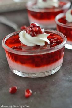 two desserts with cranberry sauce and whipped cream on top sit in small glass dishes