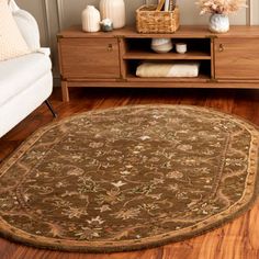 a living room scene with focus on the area rug and wooden furniture in the background