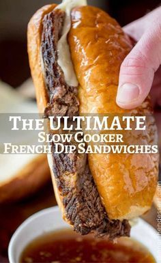 the ultimate slow cooker french dip sandwich is being held by someone's hand