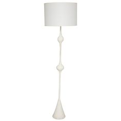 a white floor lamp with a white shade