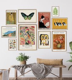 there are many posters on the wall above a bench and a plant in a vase