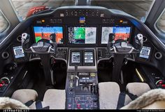 the cockpit of an airplane with two pilots and three screens showing different aircraft's flight positions