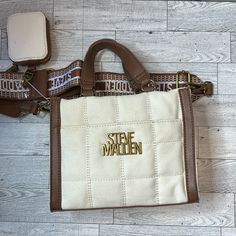 Super Cute Steve Madden Mini Tote Bag. Please View Pictures! This Bag Is A Must Add To The Collection. Comes With A Removable Strap And My Favorite, A Coin/Airpod Holder. Which Is Also Removable. Color- Bone/Cognac Trendy Cream Satchel Canvas Bag, Trendy Cream Canvas Bag With Double Handle, Trendy Beige Canvas Bag With Removable Pouch, Trendy Cream Crossbody Canvas Bag, Trendy Beige Canvas Satchel, Trendy Cream Satchel With Detachable Handle, Trendy Beige Crossbody Canvas Bag, Trendy Beige Canvas Bag With Handles, Square Beige Canvas Satchel