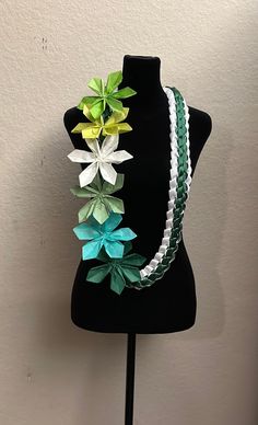 a black mannequin with three different colored flowers on it