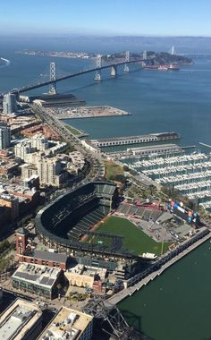 an aerial view of a baseball stadium and the bay bridge