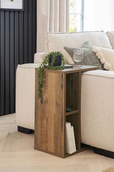 a living room with a white couch and wooden table