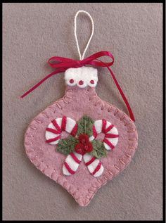 a pink ornament with candy canes on it