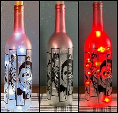 three bottles with different pictures on them and one has a light up bottle in the middle