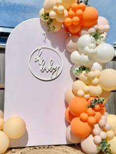 an arch made out of balloons and greenery