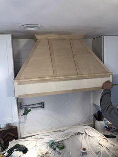 a person standing in front of a stove top oven