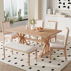 a dining room table with two chairs and a bench