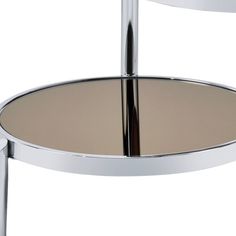 the back side of a chrome and glass table with two circular shelves on each side