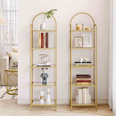 two gold bookshelves in a living room