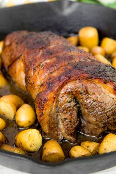 a roasting pan filled with meat and potatoes