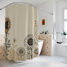 a shower curtain with sunflowers and daisies on it in a white bathroom