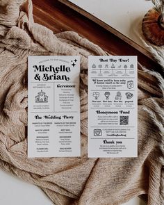 two wedding program cards sitting on top of a table next to a piece of cloth