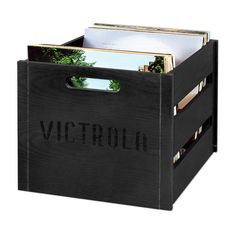 a wooden box with magazines in it and the word victoria printed on the front side