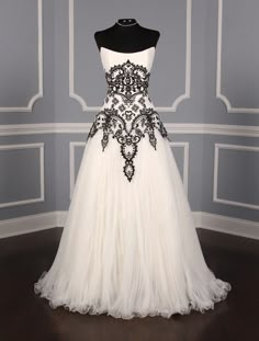 a white and black wedding dress on display