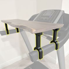 a computer desk with a laptop on it and two yellow bars running along the edge