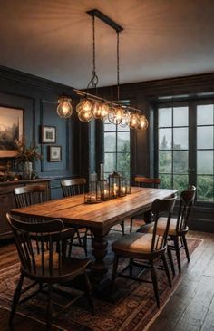 a dining room table and chairs with lights hanging from the chandelier over it