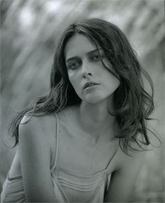 a black and white photo of a woman with long hair